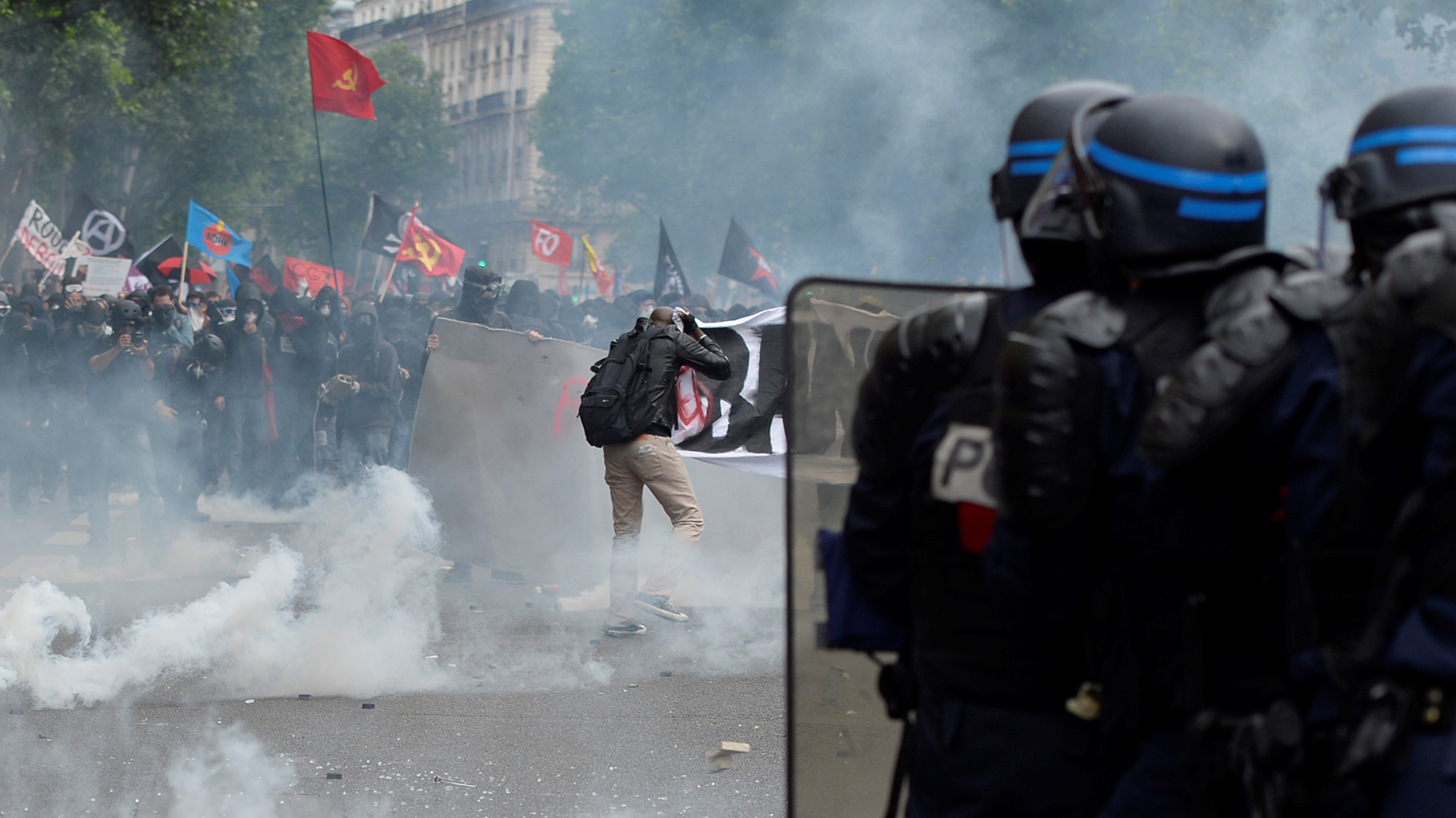 Demonstrators clash with police officers during a protest against proposed labour reforms in Paris on June 14, 2016.  Strikes closed the Eiffel Tower and disrupted transport in France on June 14 as tens of thousands prepared to march against labour reforms with the Euro 2016 football championship in full swing.  / AFP PHOTO / ALAIN JOCARD