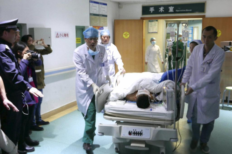 A 19-year-old survivor, who was pulled out by rescuers more than 60 hours after a landslide hit an industrial park on Sunday, is rushed to get medical treatment at a hospital in Shenzhen, Guangdong province, China, December 23, 2015. REUTERS/China Daily ATTENTION EDITORS - THIS PICTURE WAS PROVIDED BY A THIRD PARTY. THIS PICTURE IS DISTRIBUTED EXACTLY AS RECEIVED BY REUTERS, AS A SERVICE TO CLIENTS. CHINA OUT. NO COMMERCIAL OR EDITORIAL SALES IN CHINA.       TPX IMAGES OF THE DAY