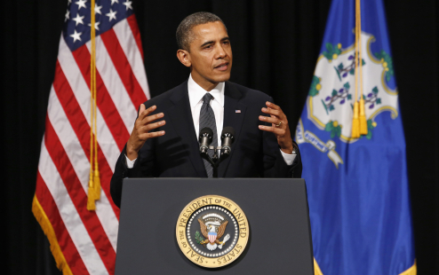 U.S. President Barack Obama gestures as he speaks at a vigil held at Newtown High School for families of victims of the Sandy Hook Elementary School shooting in Newtown, Connecticut